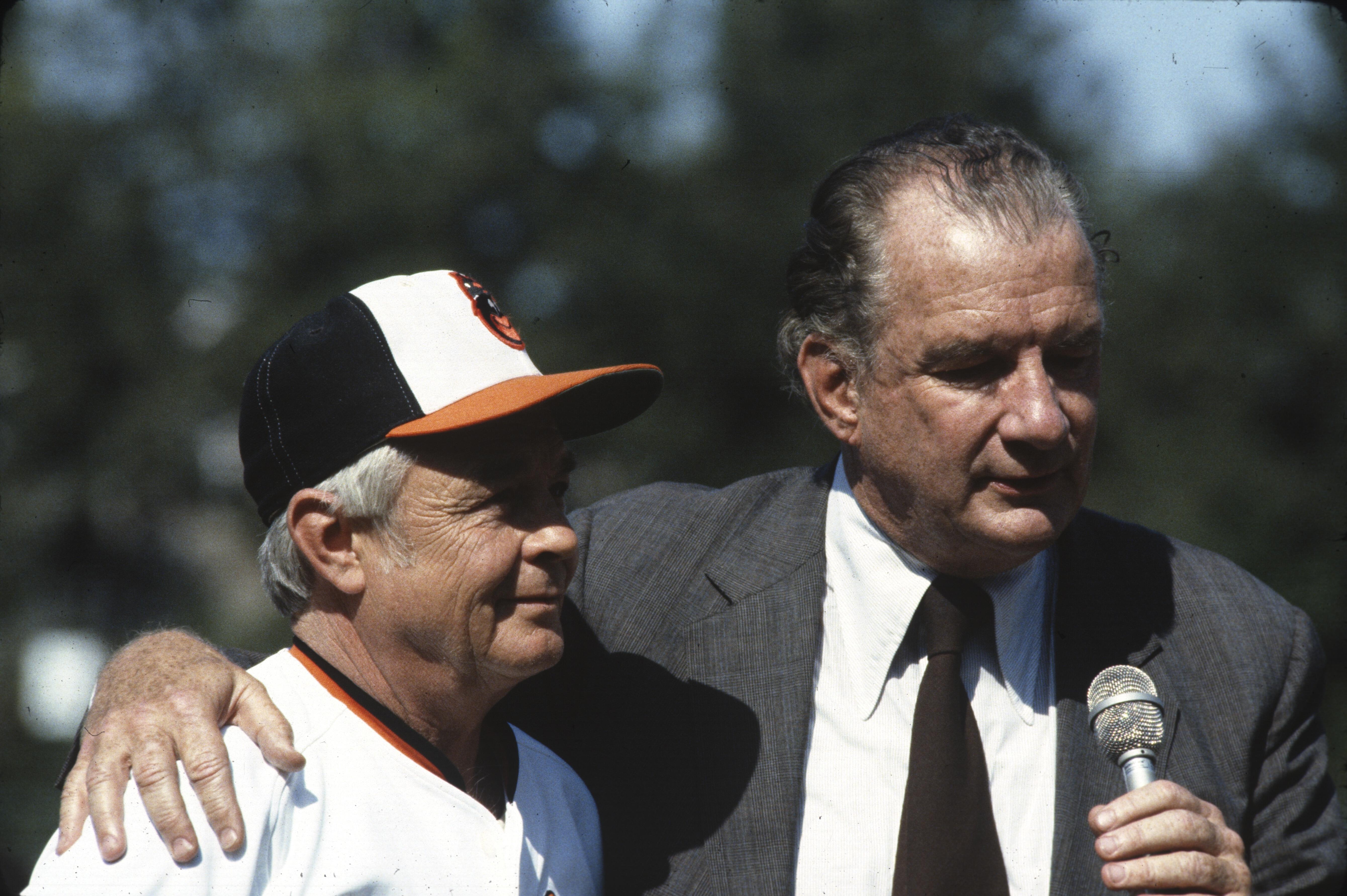 Williams Edward Bennett standing on field with Weaver