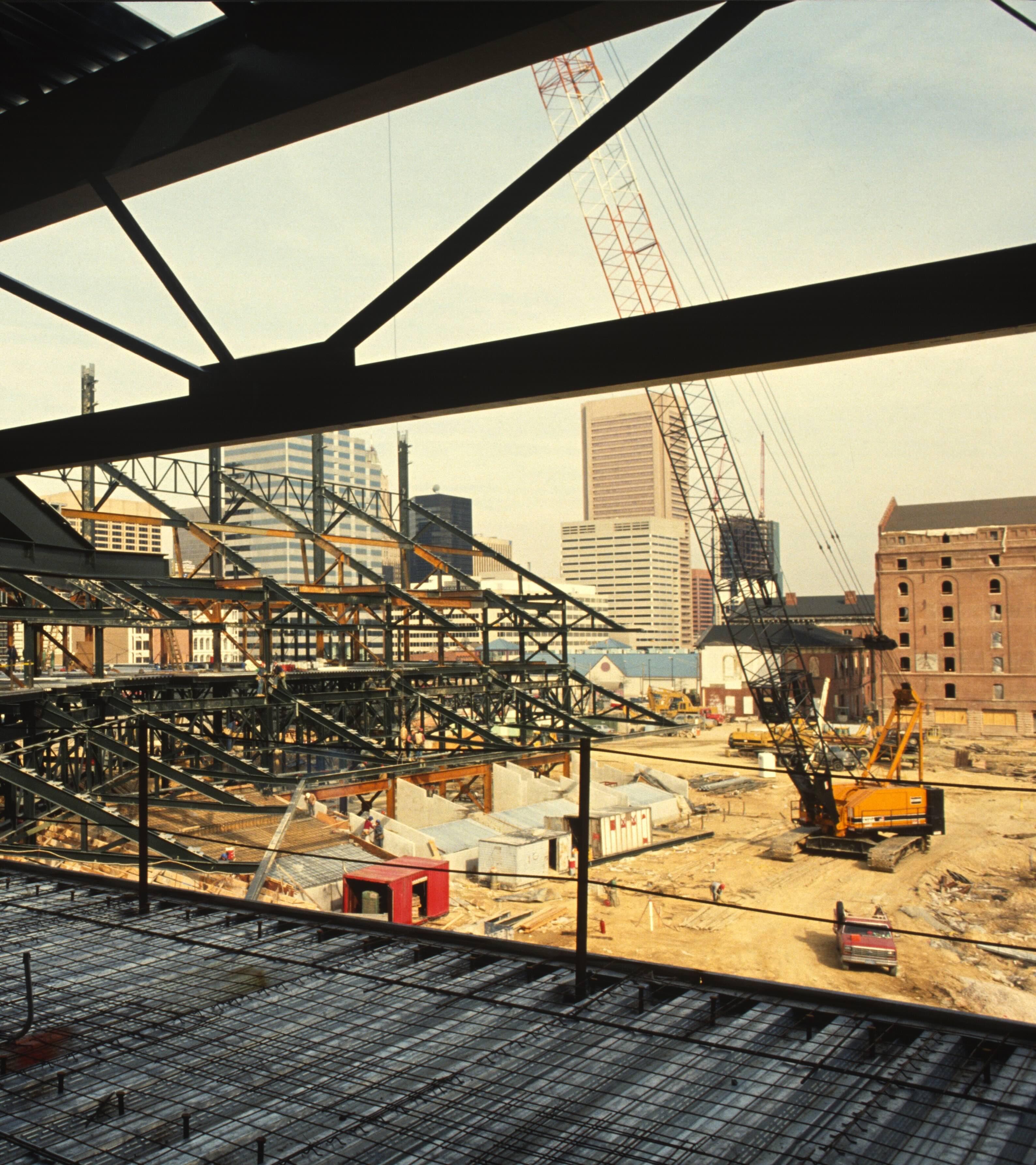 Construction site beside the long brick B&O Warehouse with cranes and scaffolding visible.