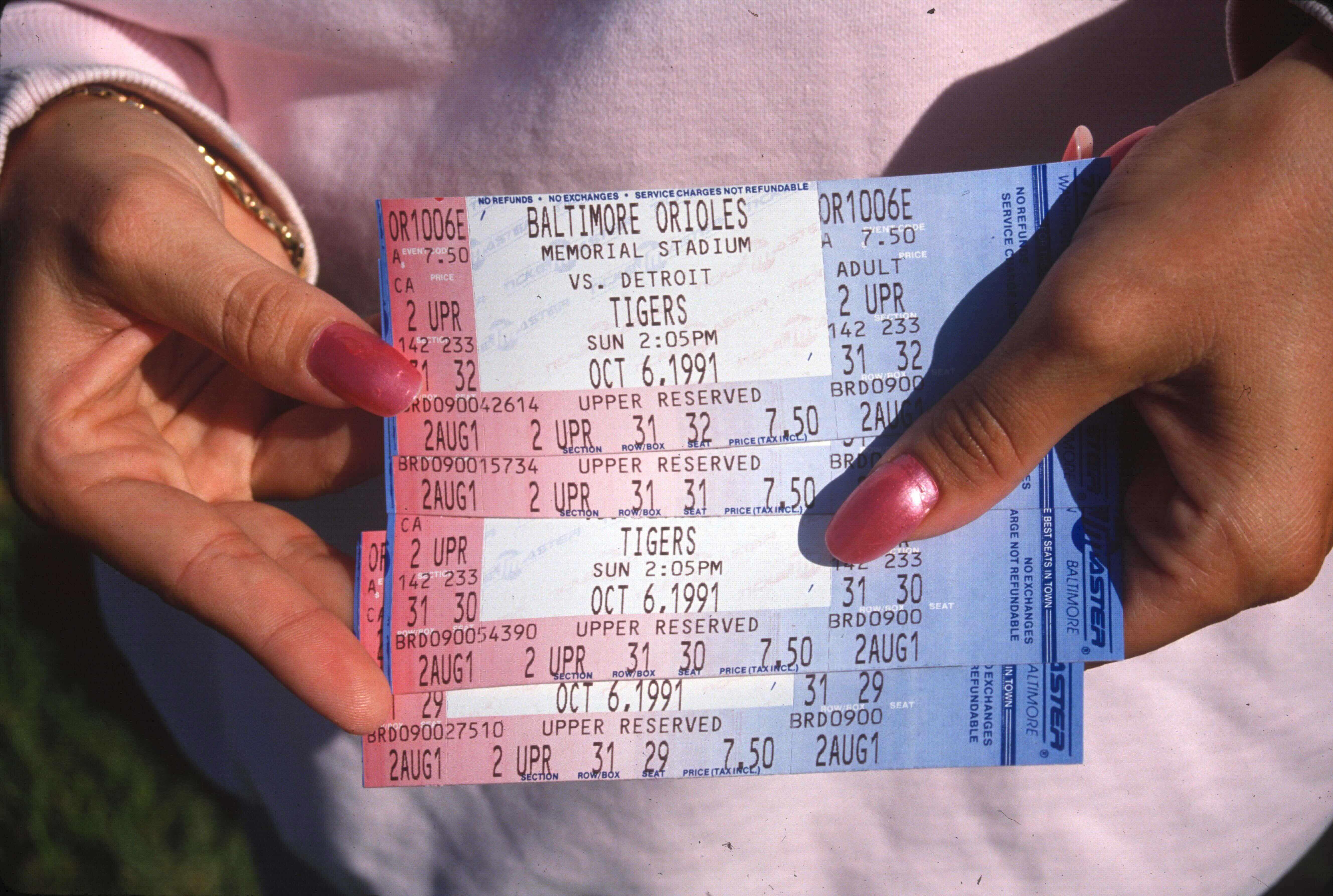 Close up of fan holding tickets to the final game