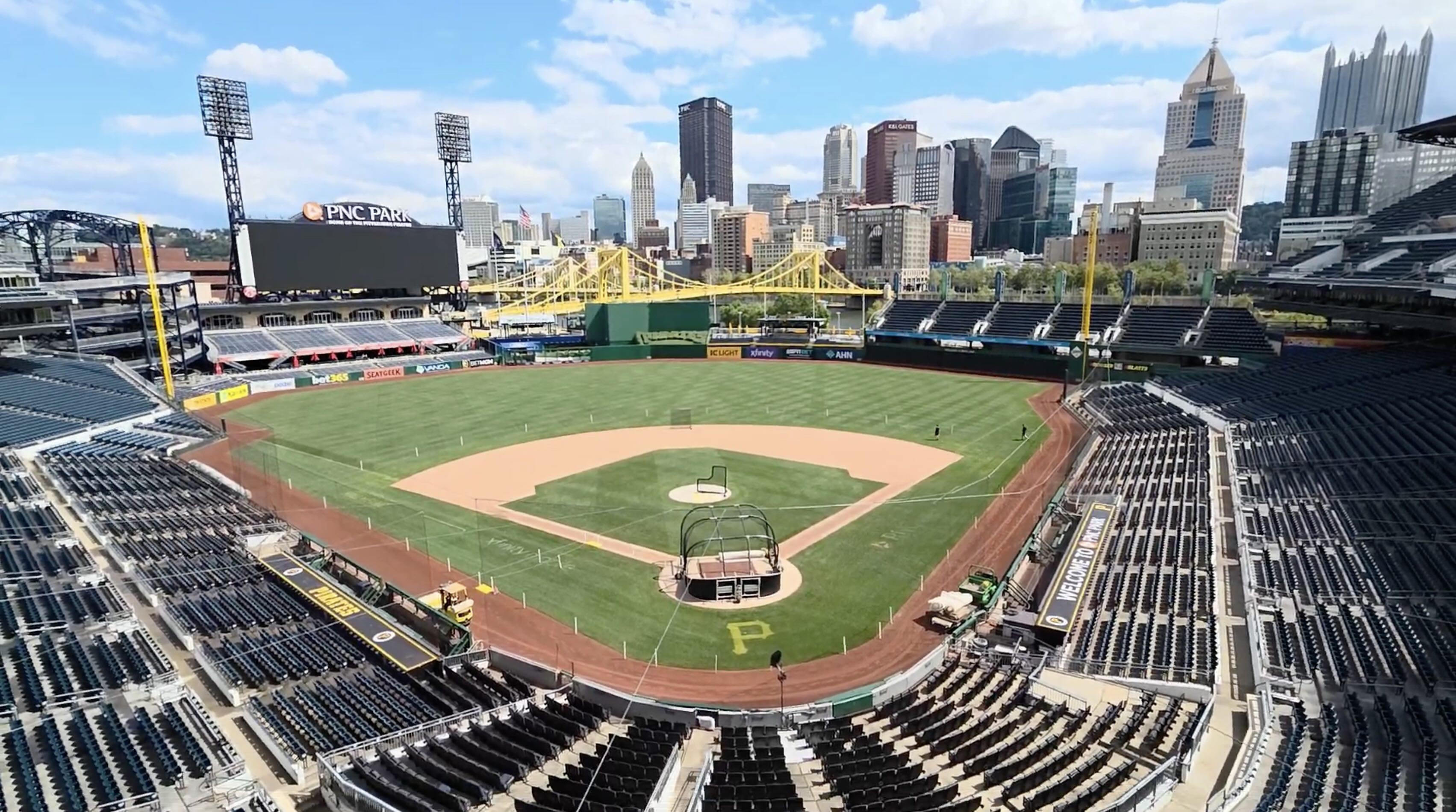 Wide view of PNC park including field, stadium seats, and the yellow bridge and skyline in the background