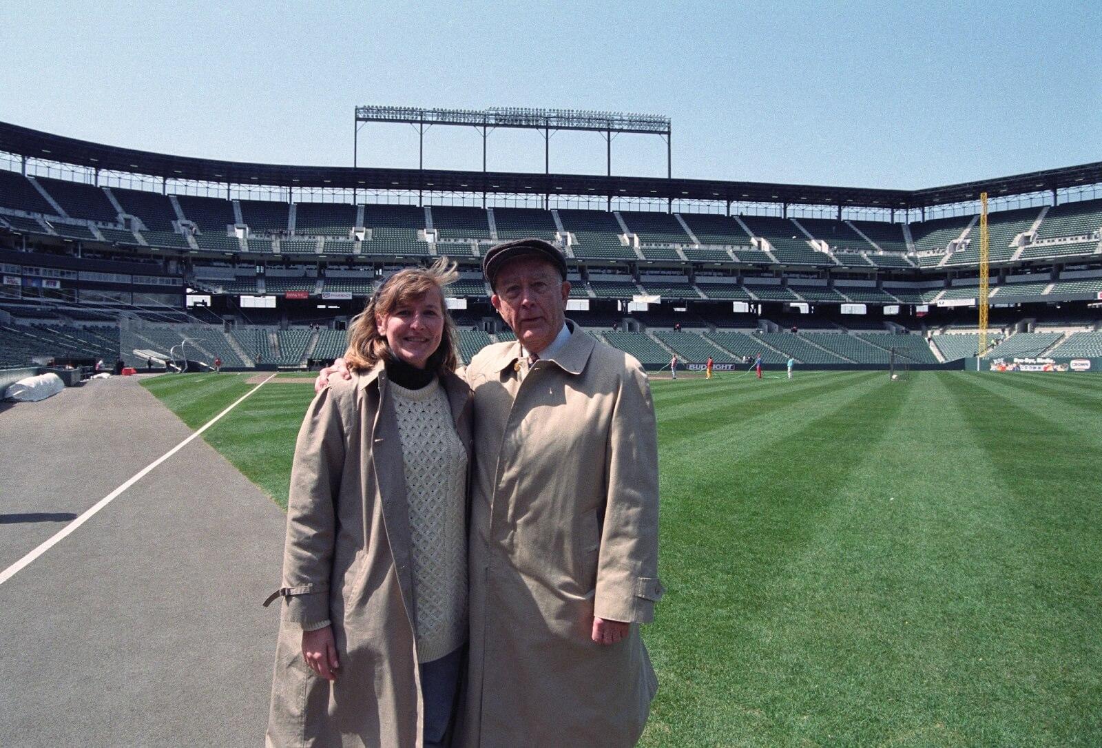 William Schaefer stands on the field at Camden Yards with a woman the day before opening day.