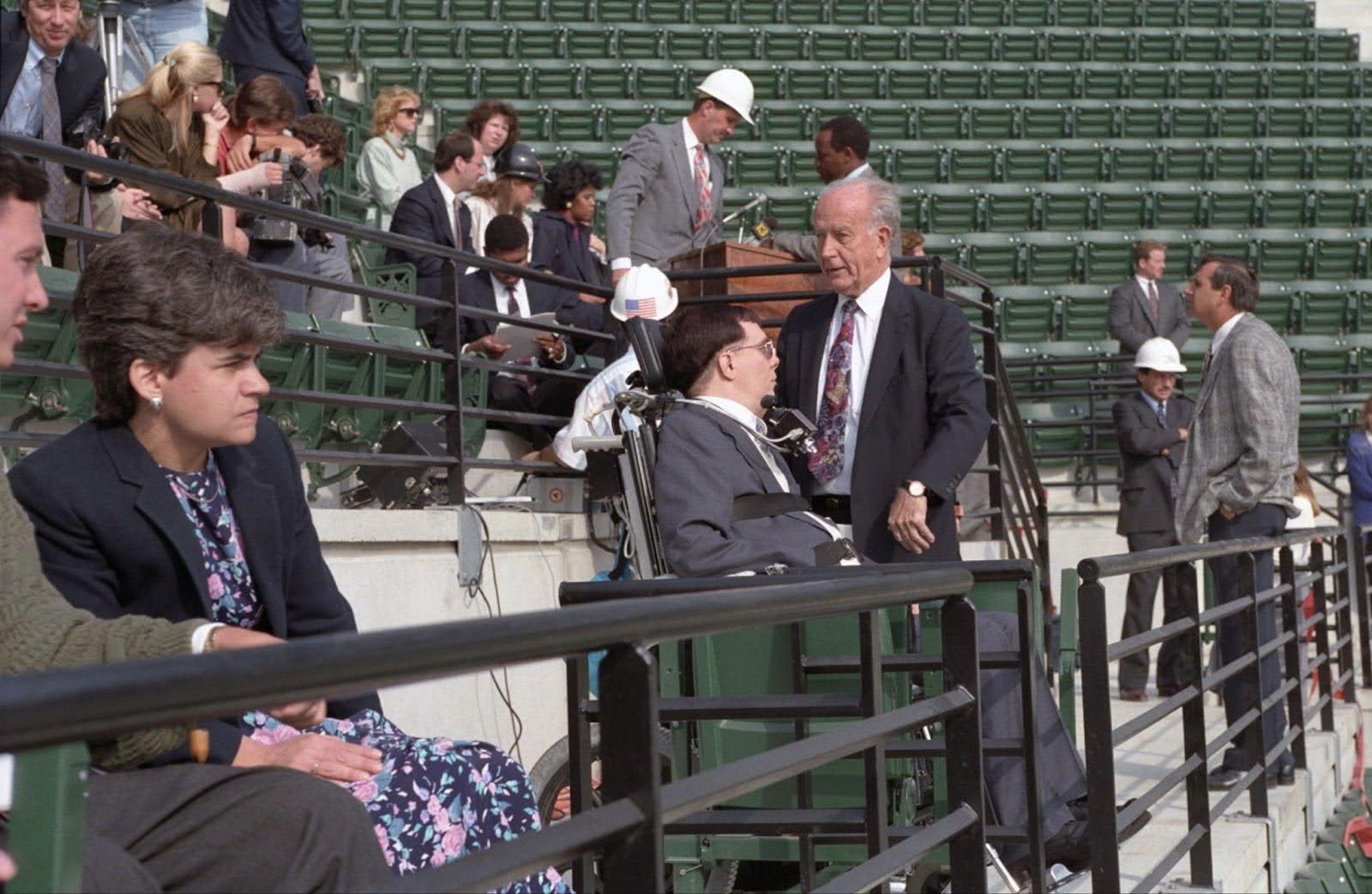Officials and visitors sit and talk in newly installed seats during a tour of Oriole Park at Camden Yards.