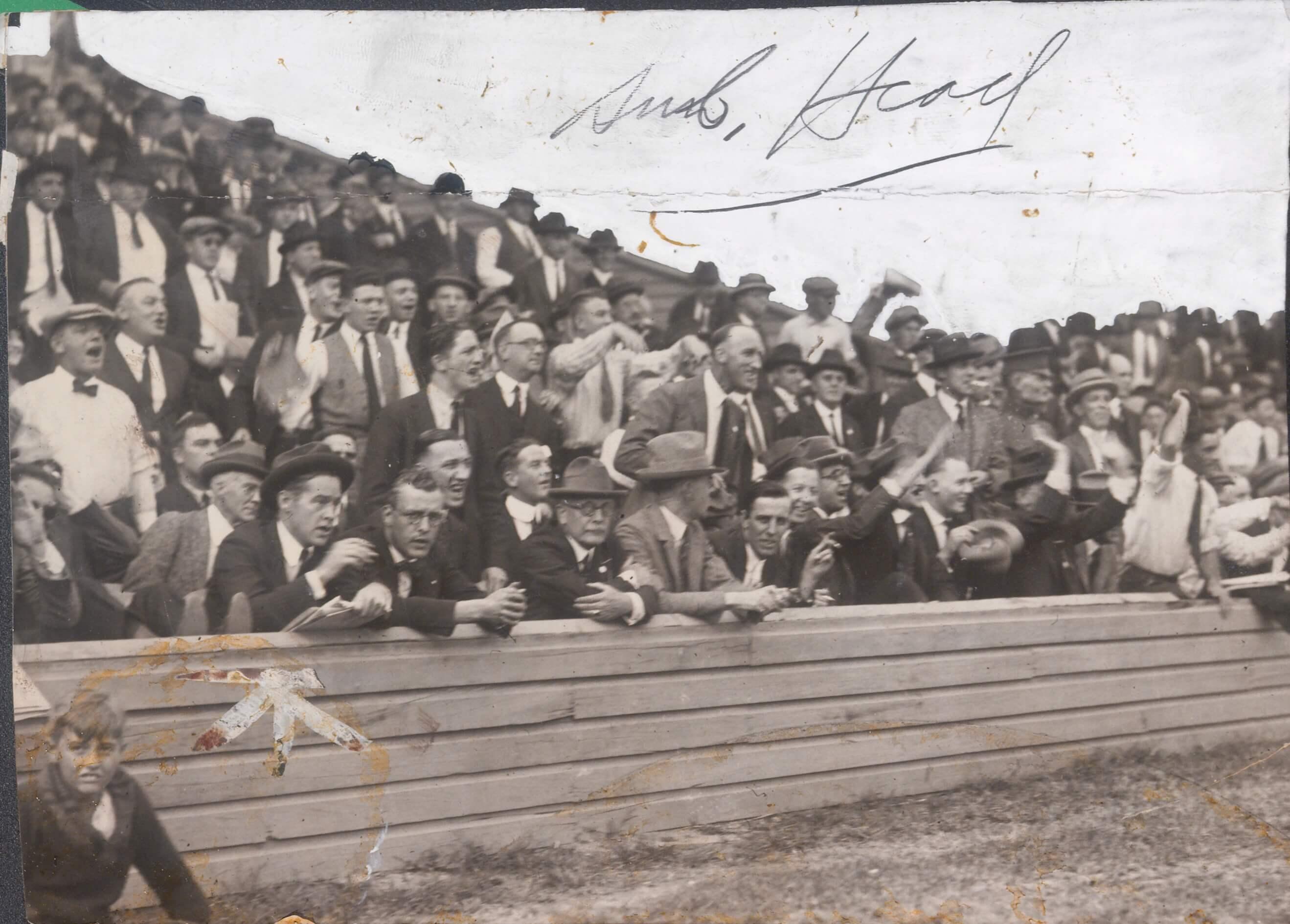 Early 20th-century baseball fans in suits and hats